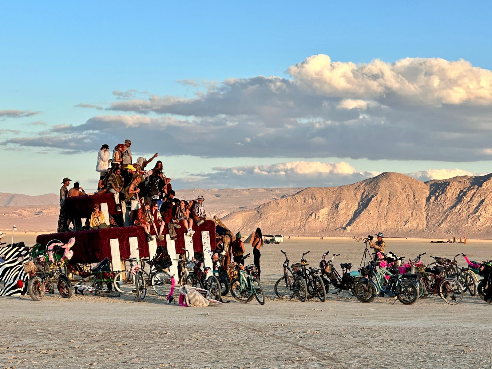 BYTE Project art car in the desert with people gathered at sunset